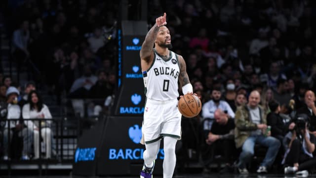 Milwaukee Bucks guard Damian Lillard (0) sets the play 